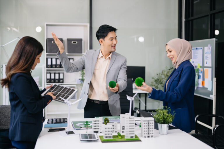 Business people having consultation about wind energy at company office. Business team discussing about windmill and alternative green energy. Executive meeting at modern office